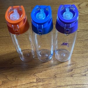 3 Az Pro water bottles, orange, navy and purple.